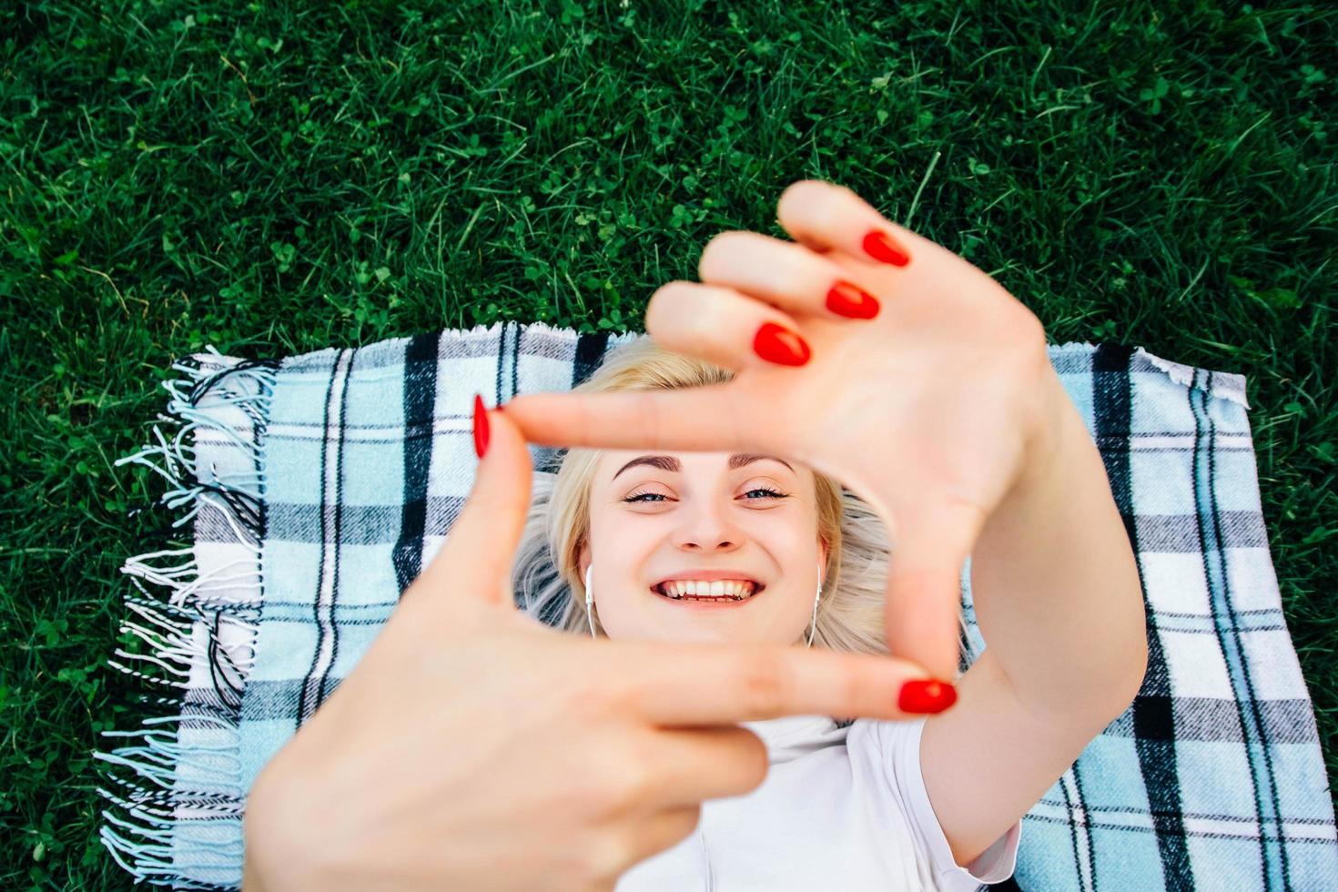 Woman smiling making frame with hands and fingers with happy face photo