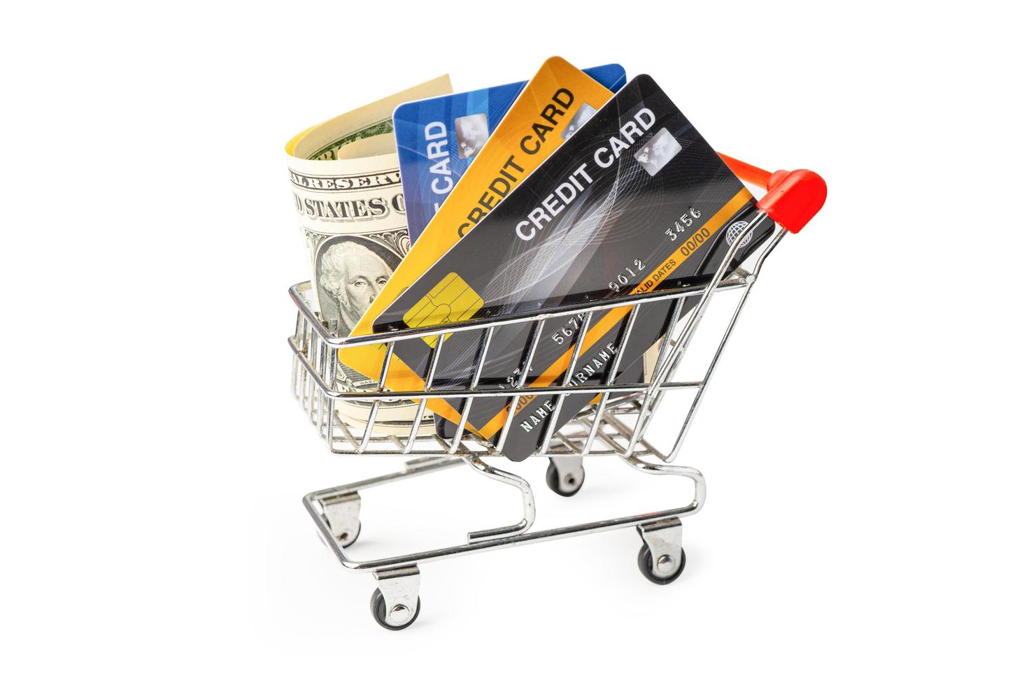 Credit card and US dollar banknotes in shopping cart isolated on white background, finance concept. photo