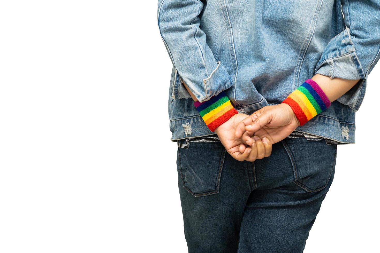 Asian lady wearing rainbow wristbands isolate on white background with clipping path, symbol of LGBT pride month celebrate annual in June social of gay, lesbian, bisexual, transgender, human rights. photo