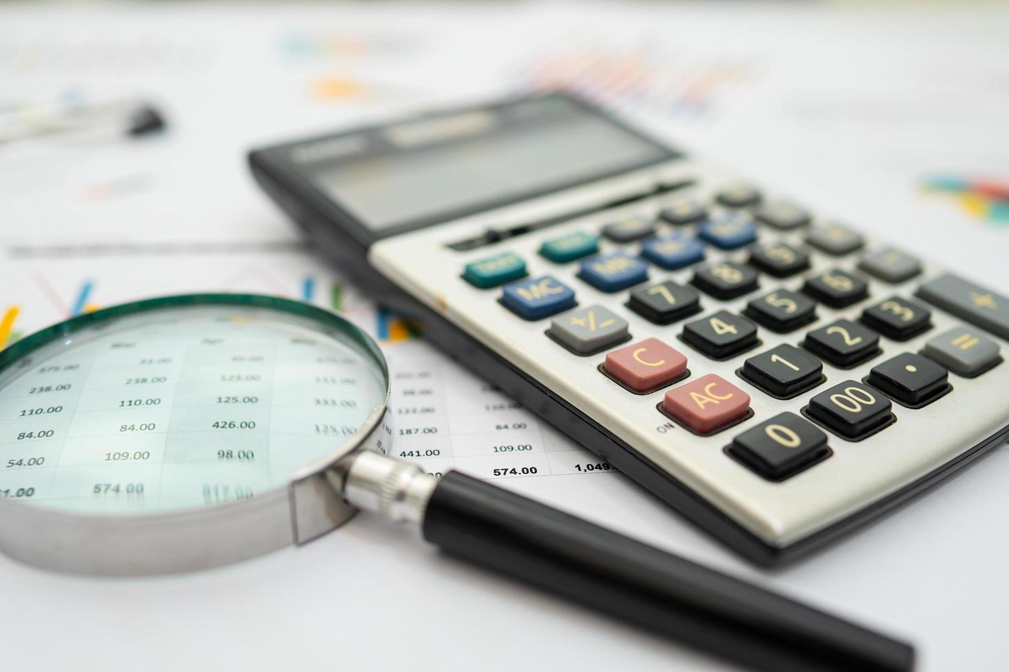 Calculator on chart and graph spreadsheet paper. Finance development, Banking Account, Statistics, Investment Analytic research data economy, Stock exchange trading, Business company concept. photo