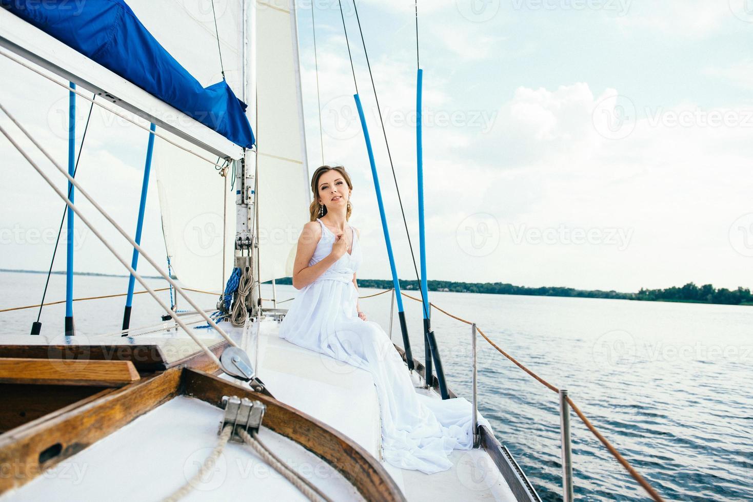 young girl on deck of sailing wooden yacht photo