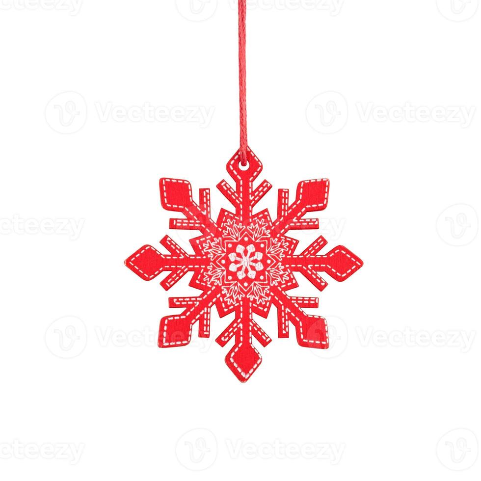 Hanging red wooden snowflake, rustic Christmas tree ornament isolated on white background. photo