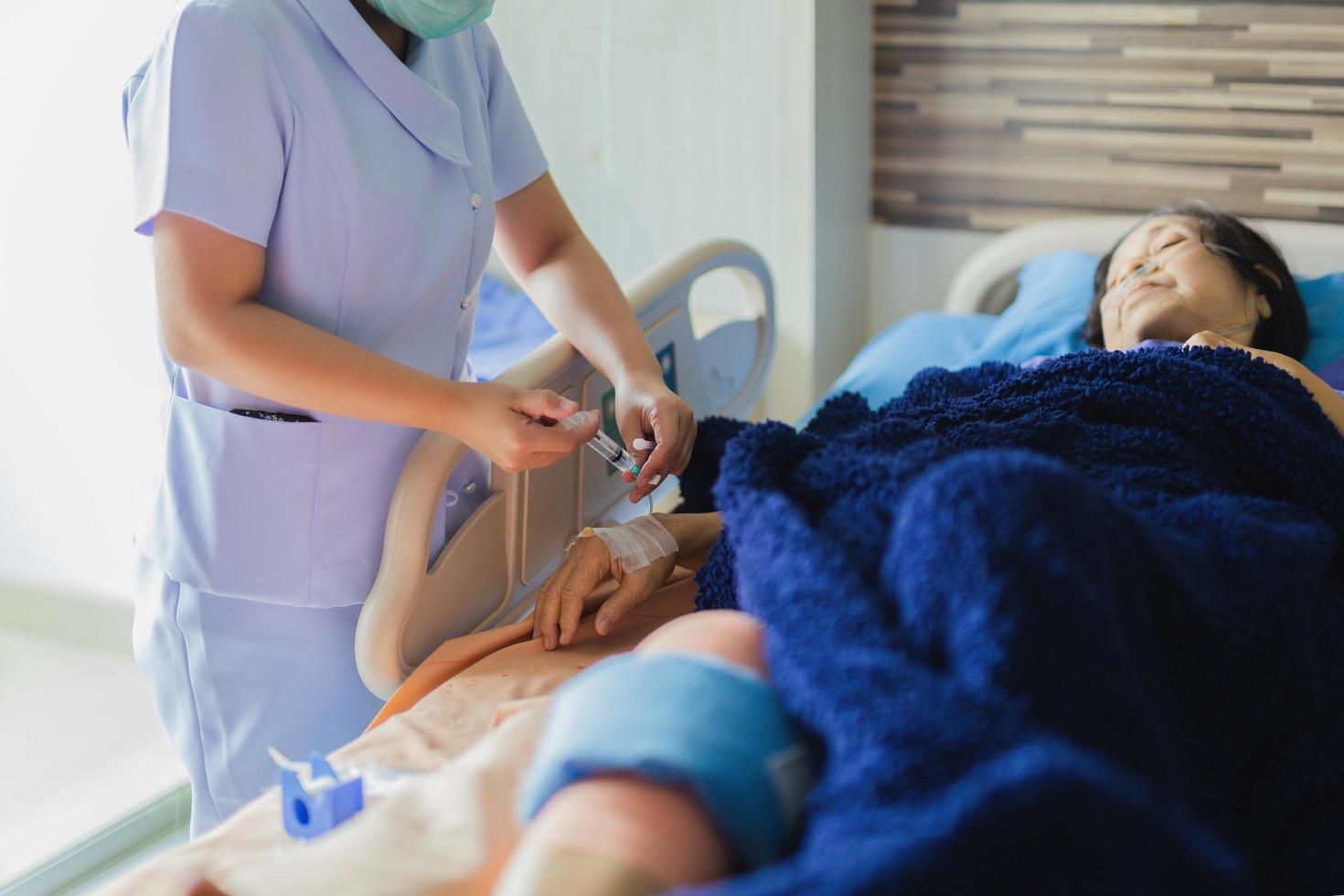 Nurse giving an injection to a patient at the hospital. photo