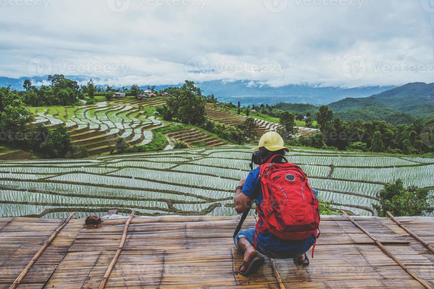 man asians travel nature. Travel relax. Walking take a photo on the field. in summer.