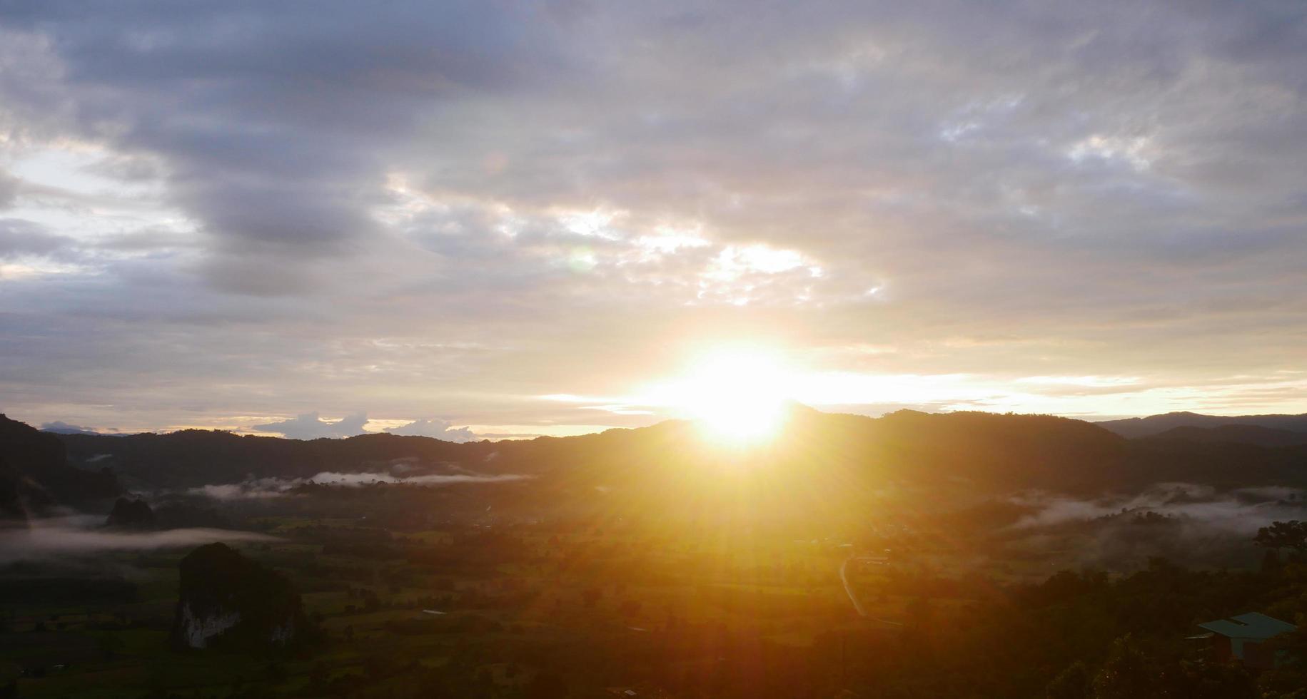 Landscape sunrise over mountains and warm morning sun photo