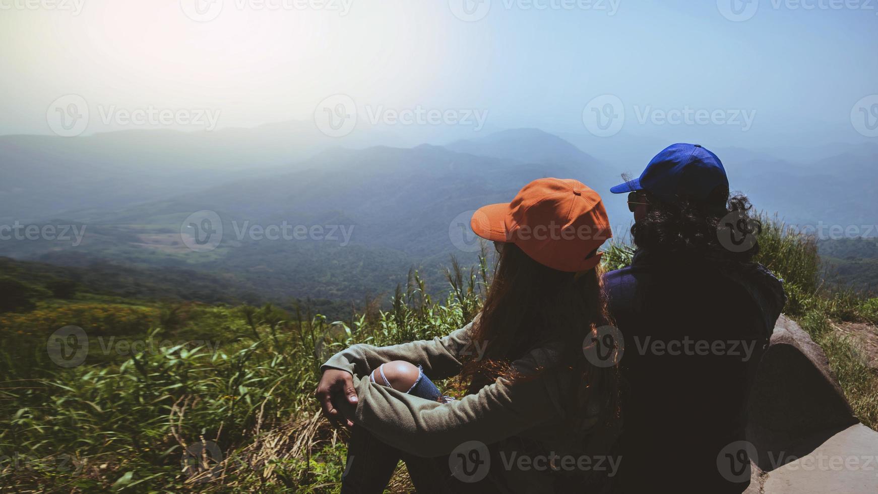 Lover women and men asians travel relax in the holiday. Happy to travel in the holiday. Lovers walk hand in hand on rice field. During the foggy winter photo