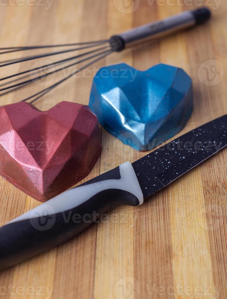 heart shaped candle on wooden background photo