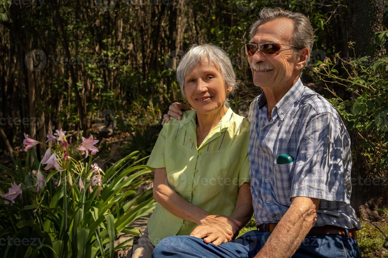 Elderly couple hugging in outdoor park. photo