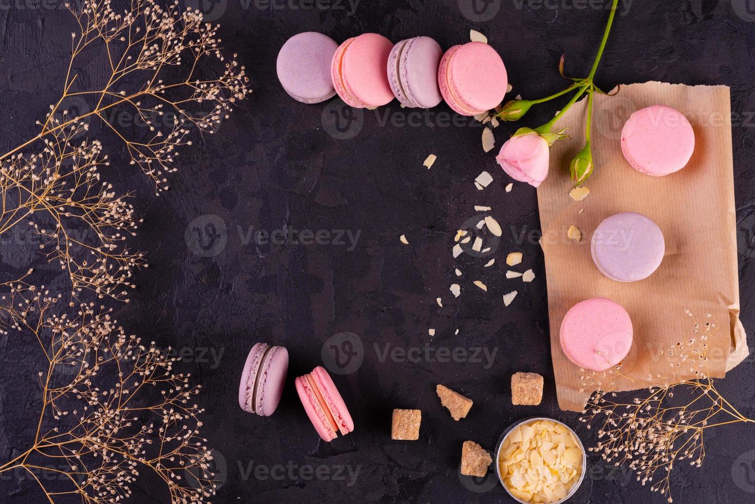 Beautiful pink tasty macaroons on a concrete background photo