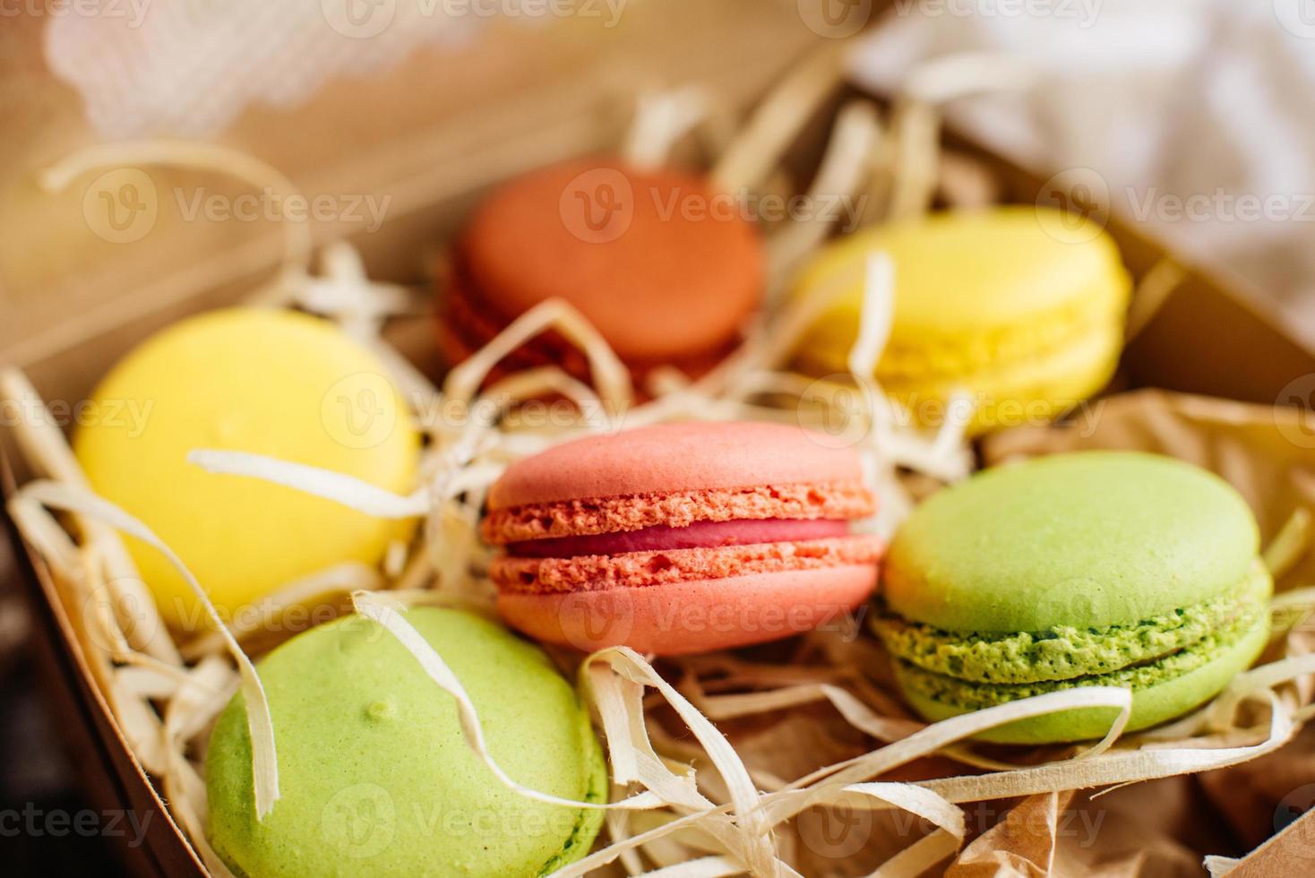 Hermosos macarrones rosados sabrosos sobre un fondo de hormigón foto