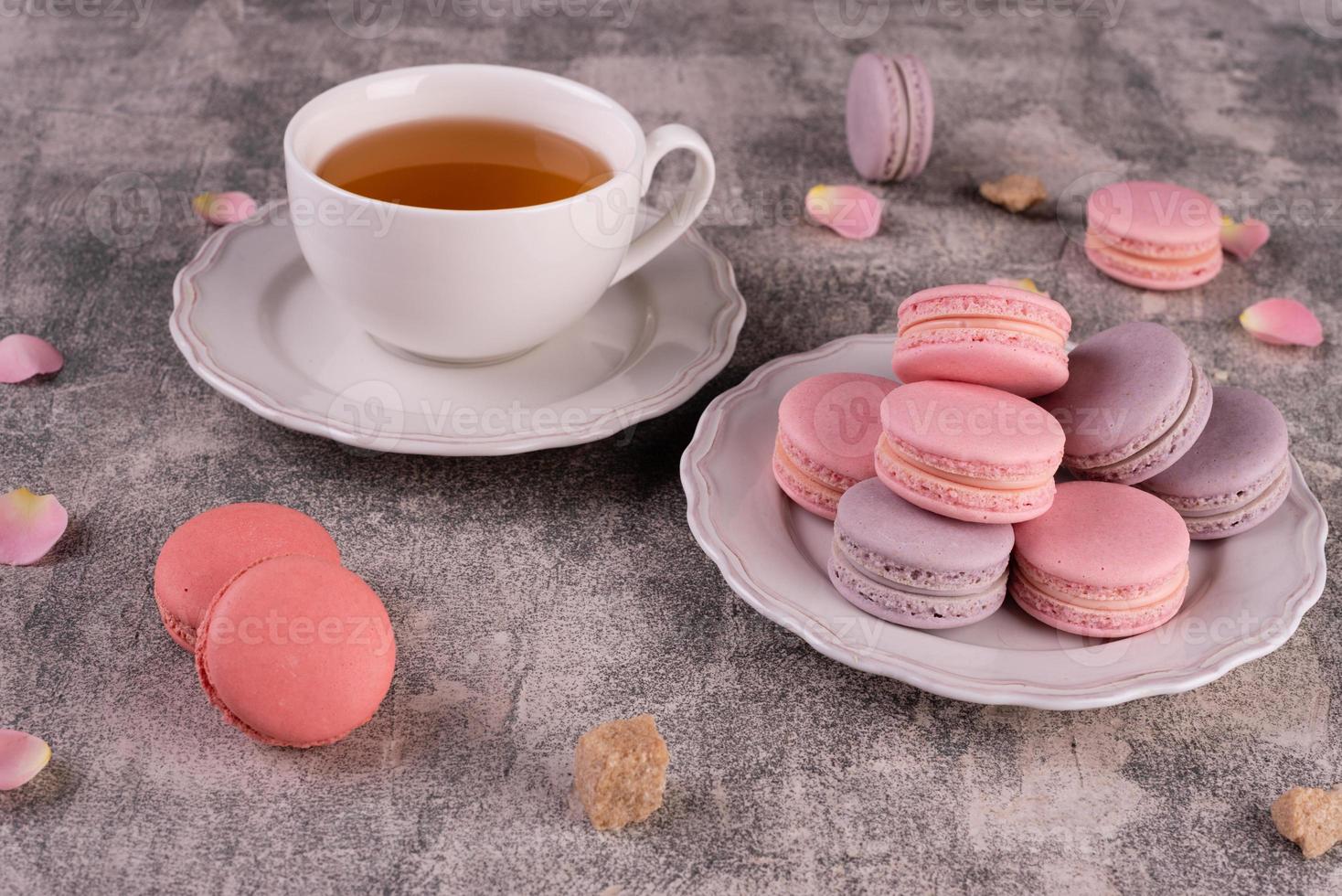 Beautiful pink tasty macaroons on a concrete background photo