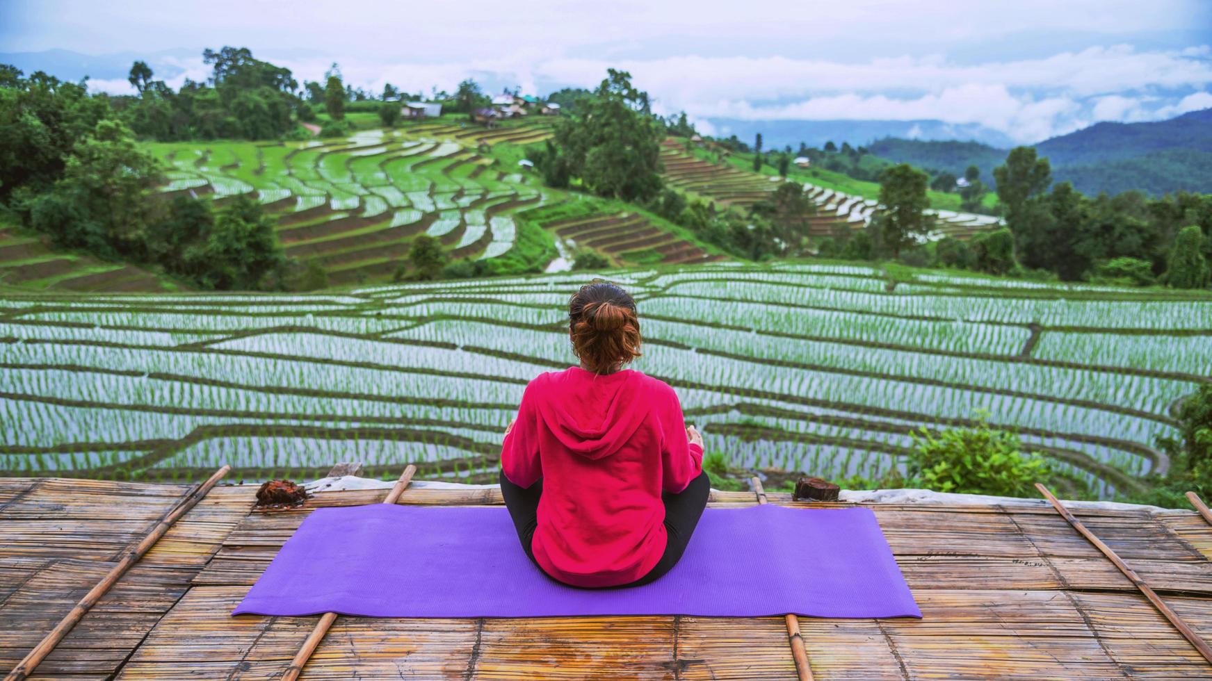 Asian woman relax in the holiday. Play if yoga. On the balcony landscape Natural Field photo