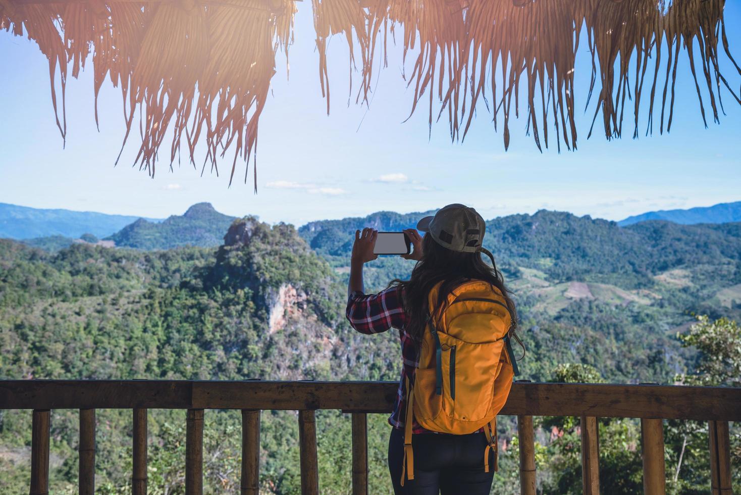 The woman standing at the view point. Enjoy shooting the natural beauty of the mountains. photo