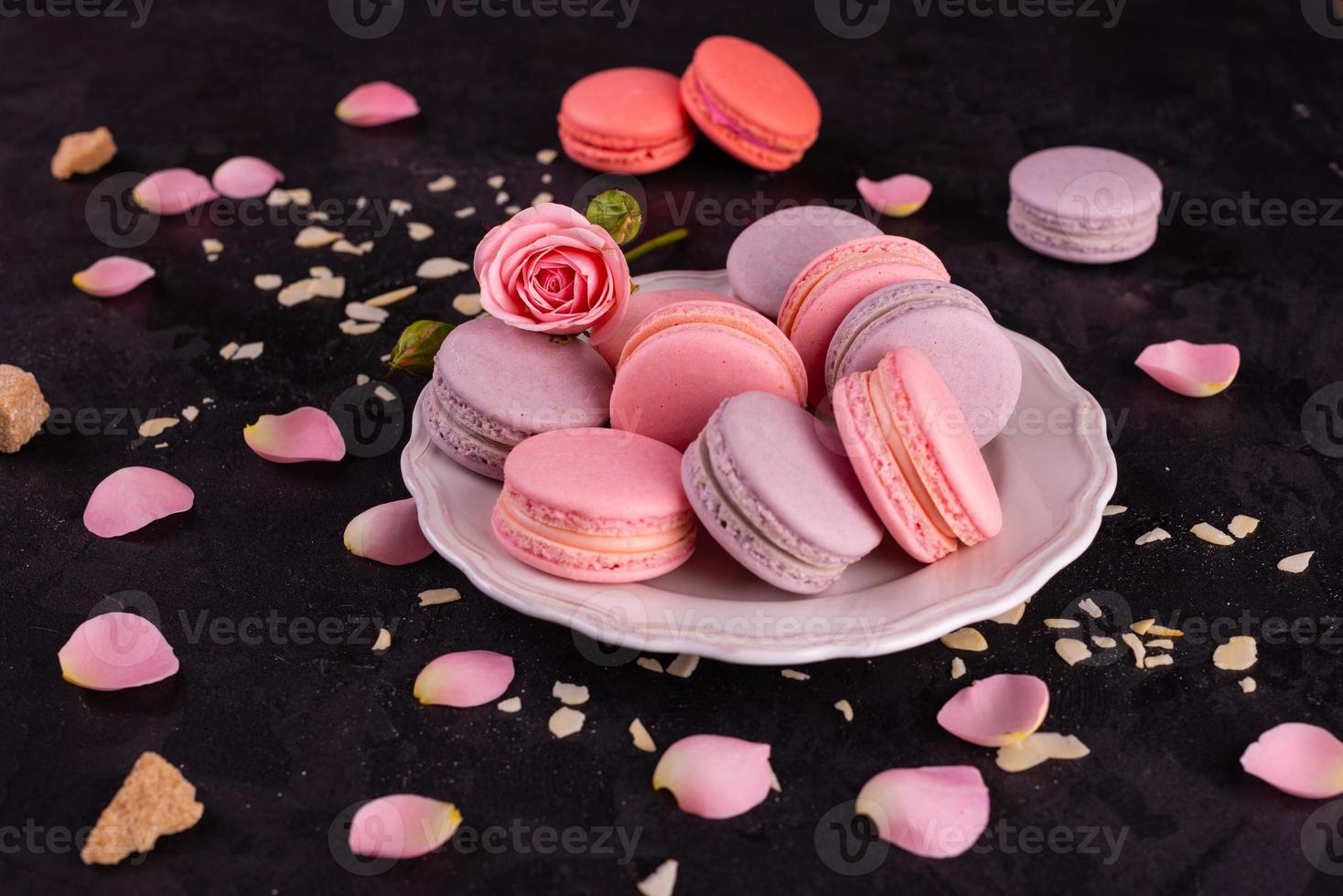 Beautiful pink tasty macaroons on a concrete background photo