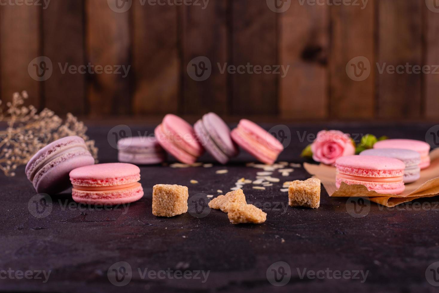 Beautiful pink tasty macaroons on a concrete background photo