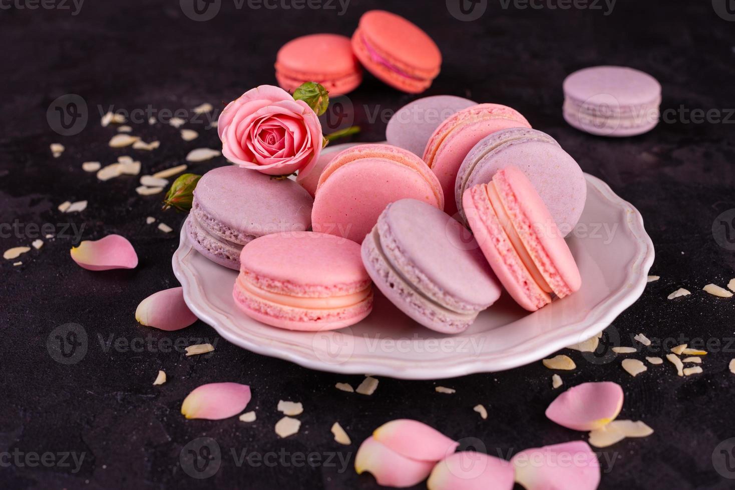 Beautiful pink tasty macaroons on a concrete background photo