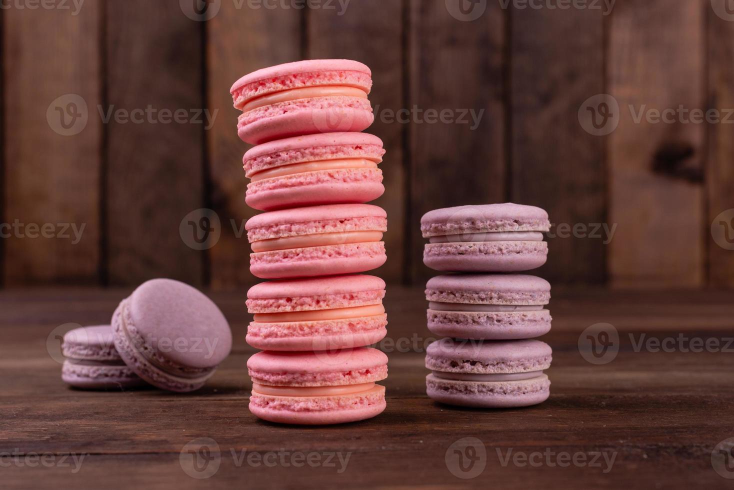Beautiful pink tasty macaroons on a concrete background photo