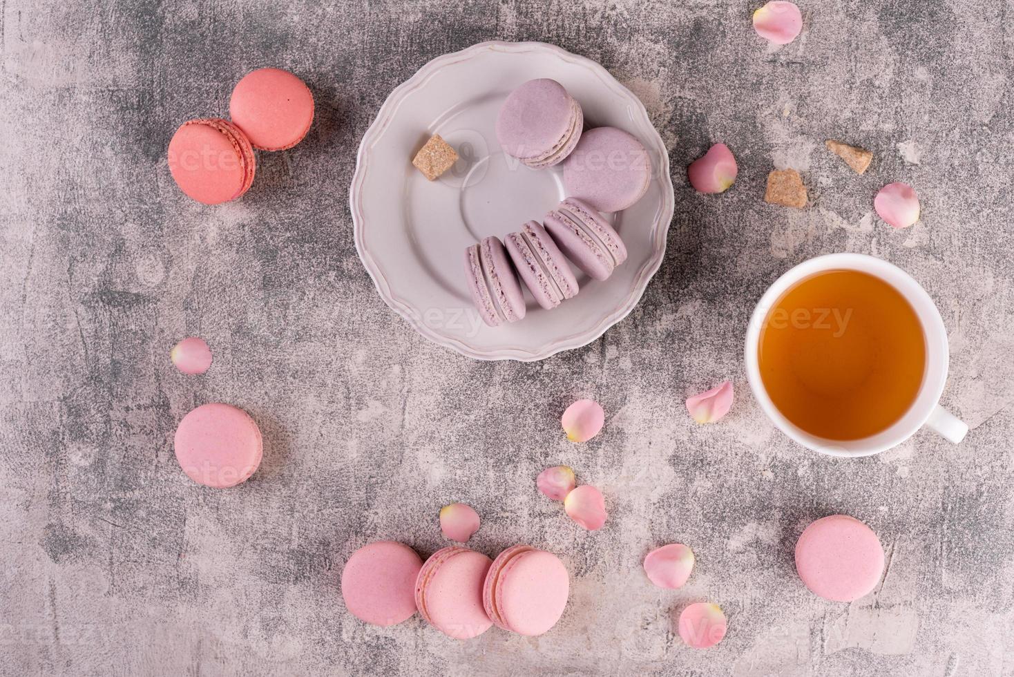 Beautiful pink tasty macaroons on a concrete background photo