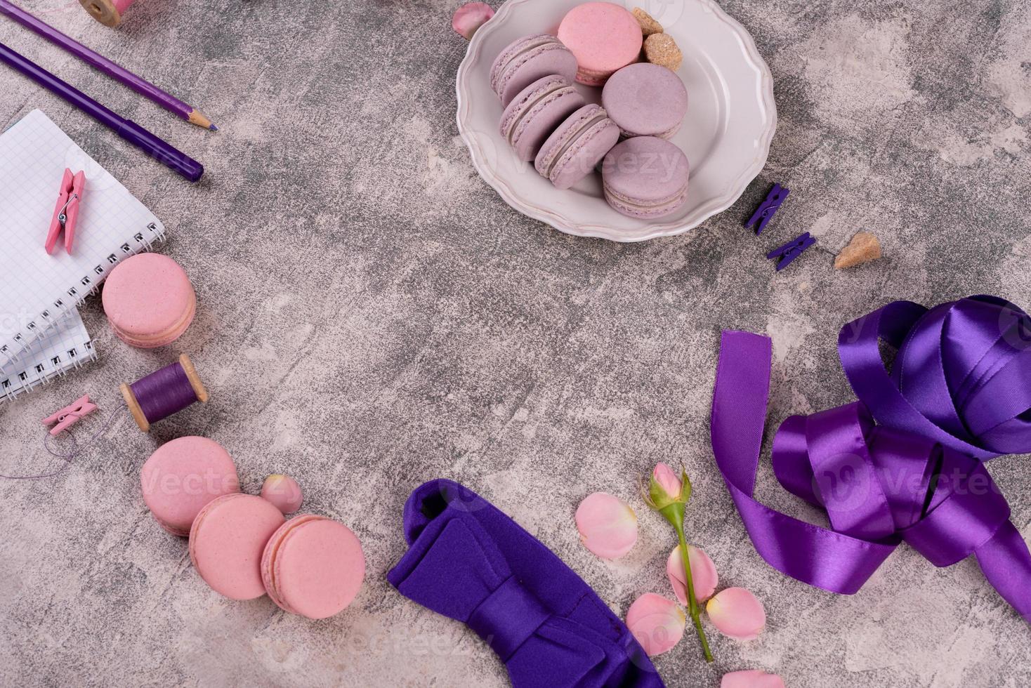 Beautiful pink tasty macaroons on a concrete background photo