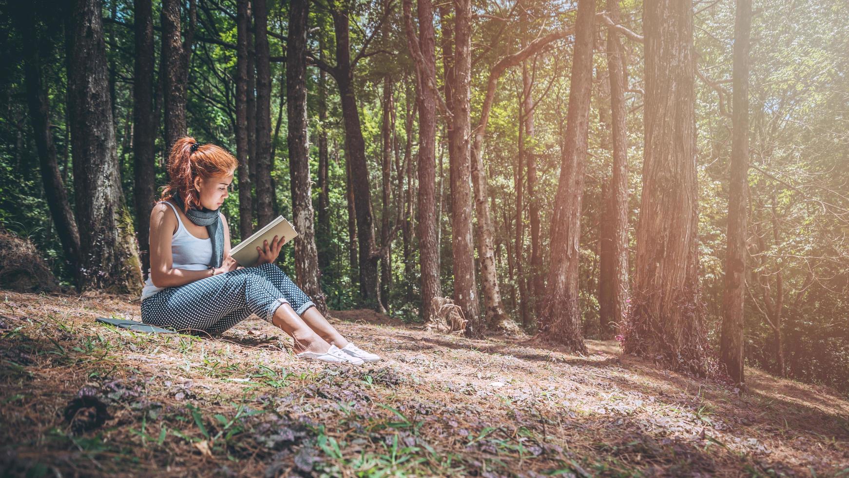 Woman relaxing reading in park. holiday photo