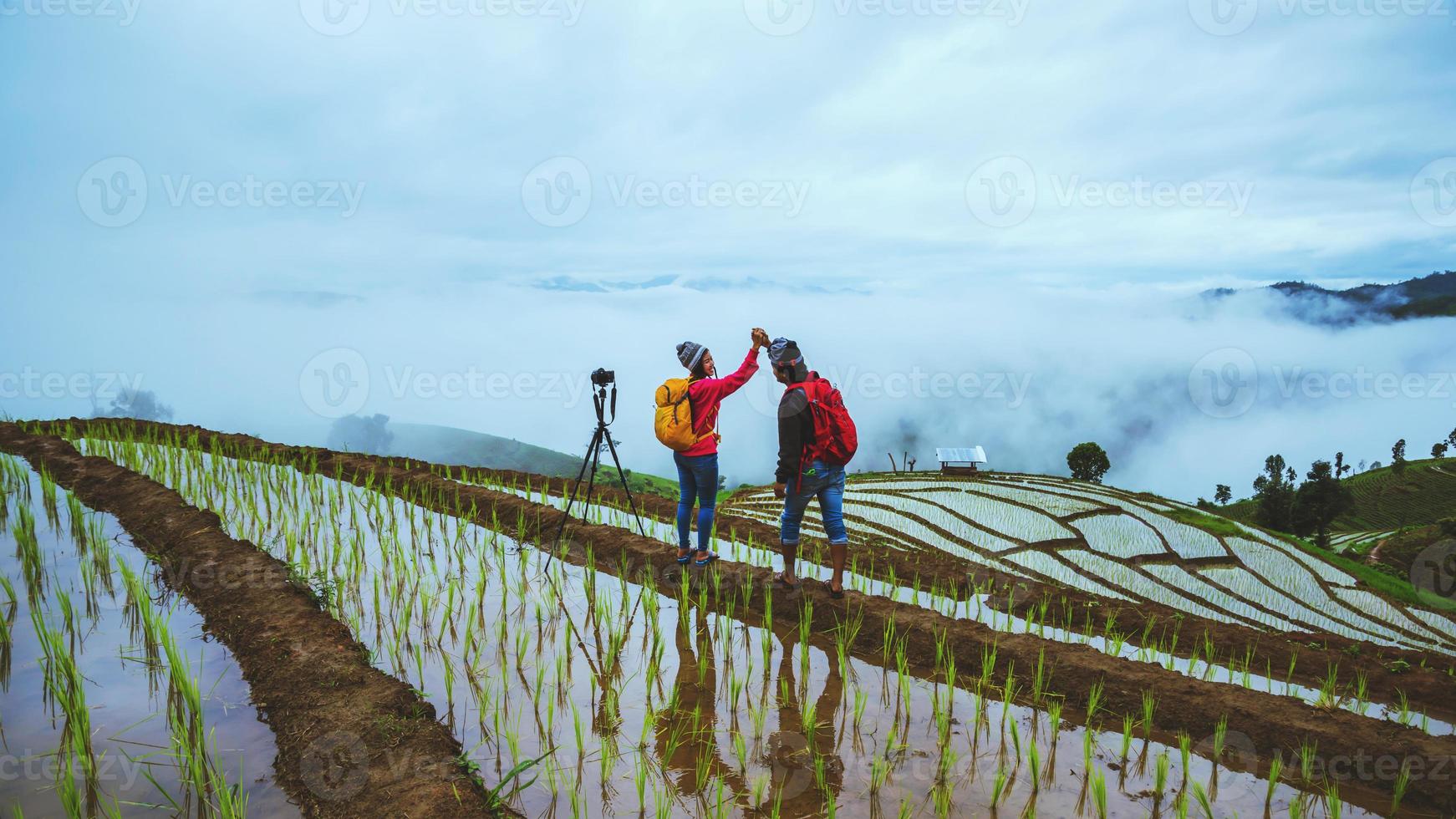 Lover woman and man Asian travel nature. Travel relax. Walking take a photo on the field. in summer.