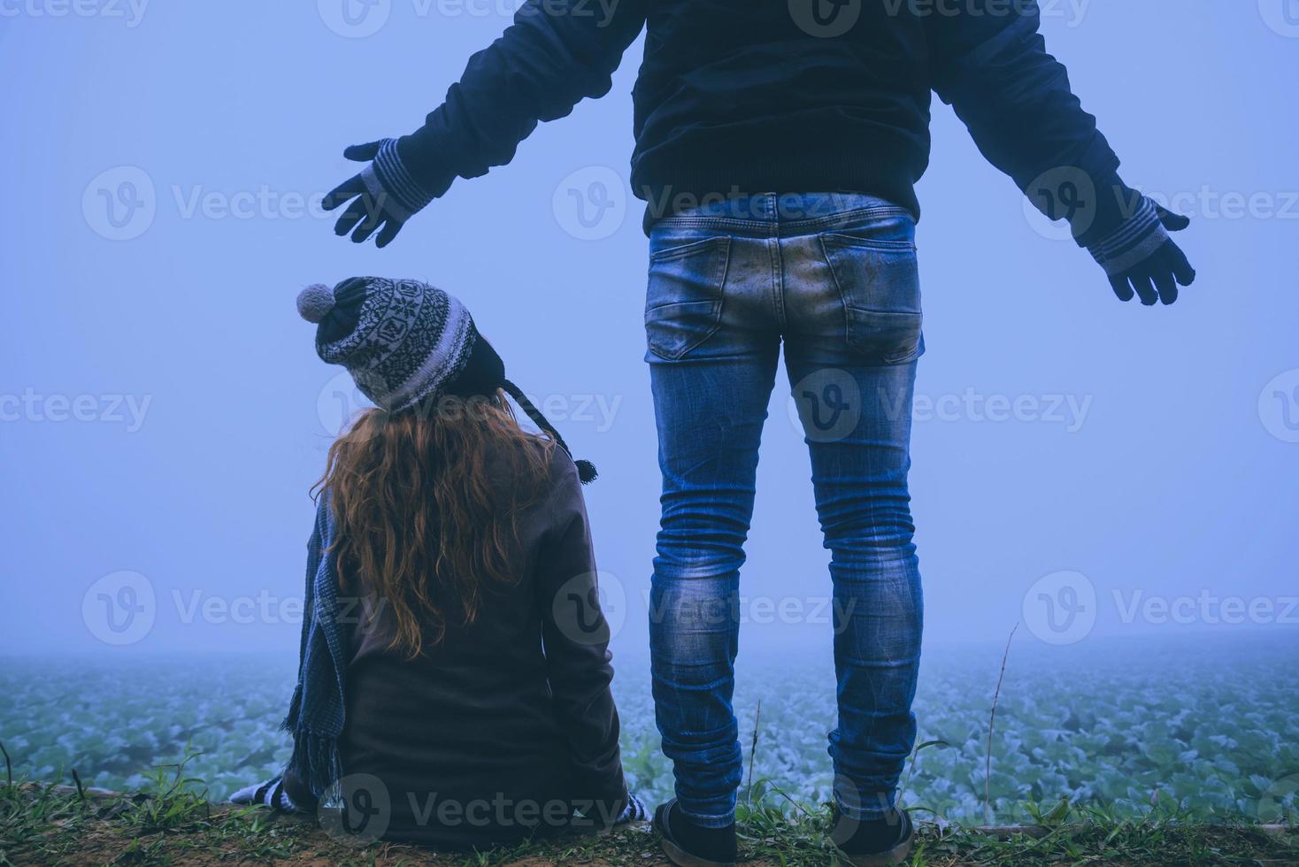 Lover women and men asians travel relax in the holiday. Happy to travel in the holiday. Lovers walk hand in hand on rice field. During the foggy winter photo