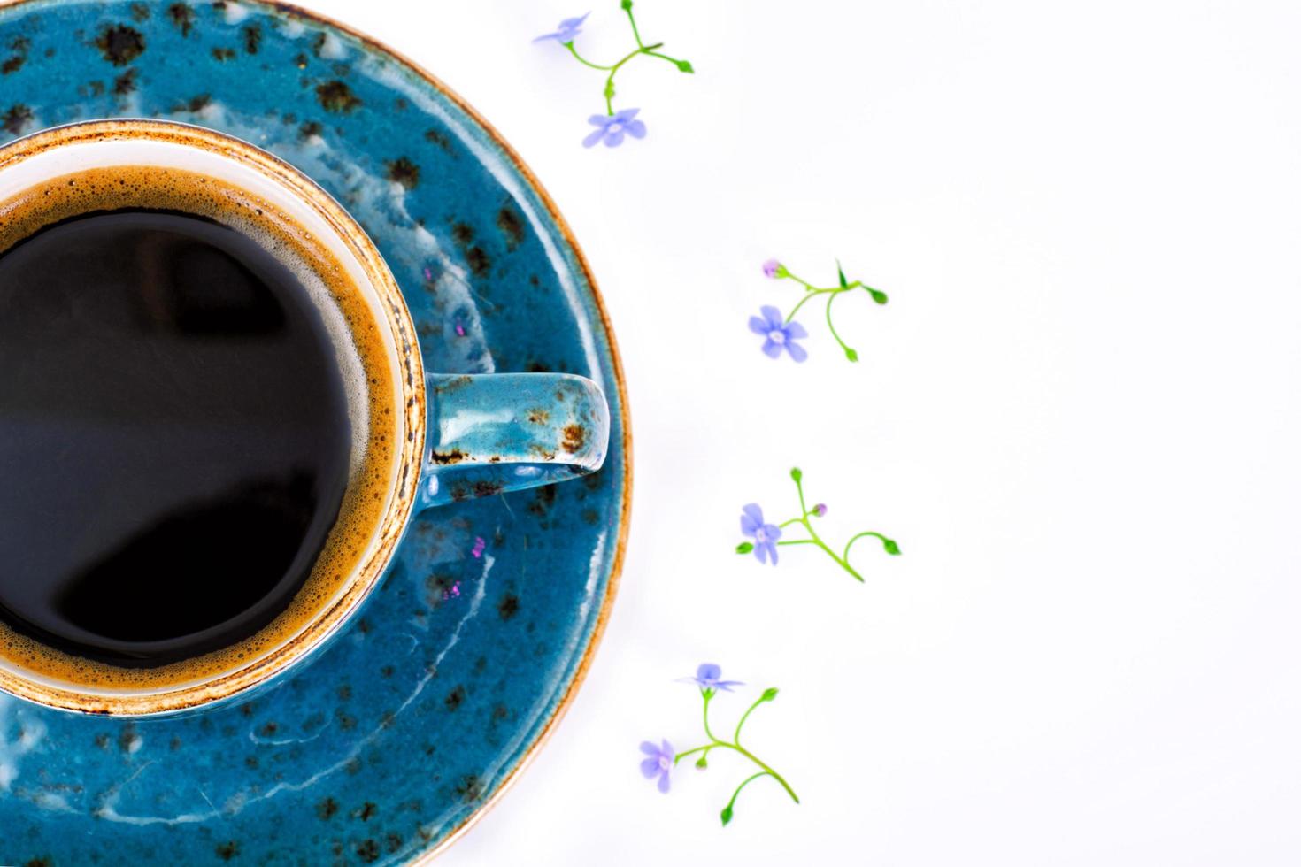 Coffee  in a blue retro cup with Flowers photo