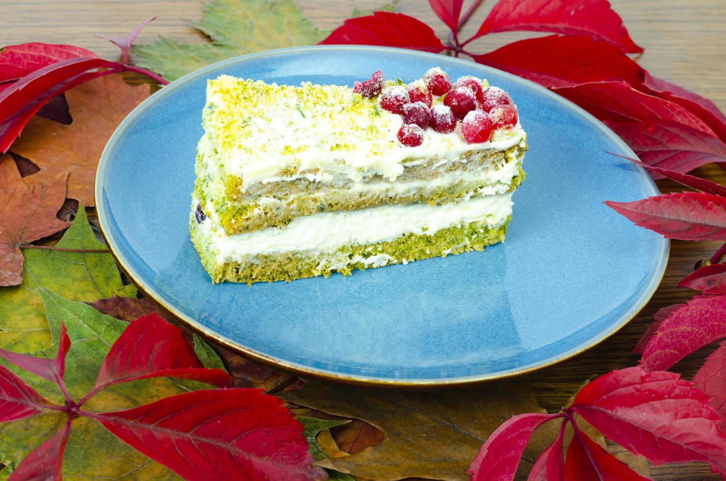 Piece of sponge cake with cream and berries on plate. Studio Photo