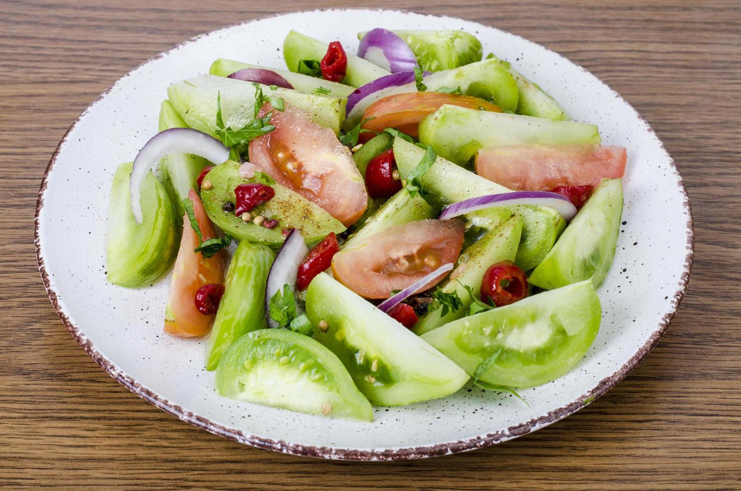 Aperitivo picante de tomates rojos y verdes en escabeche enlatados foto