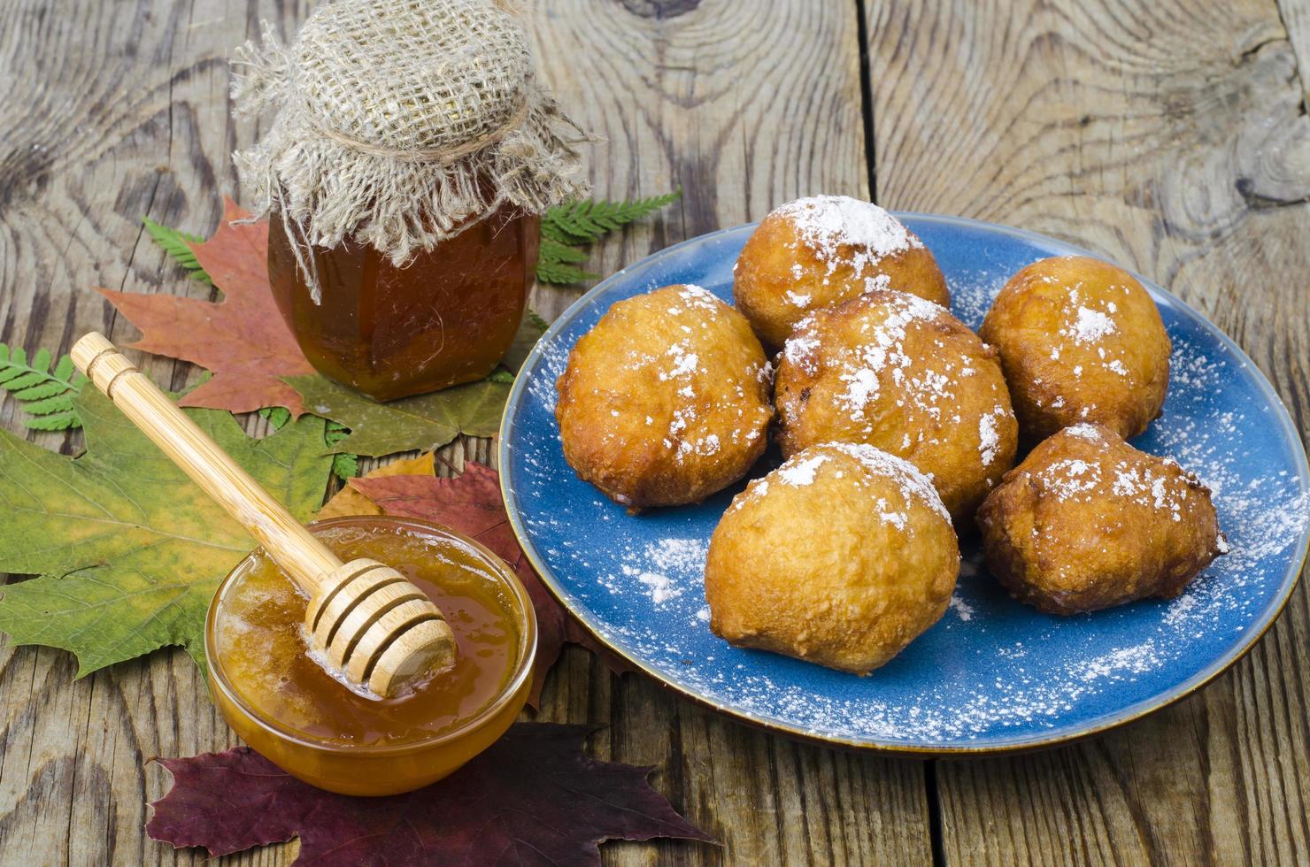 Sweet curd donuts buns with powdered sugar on wooden table photo