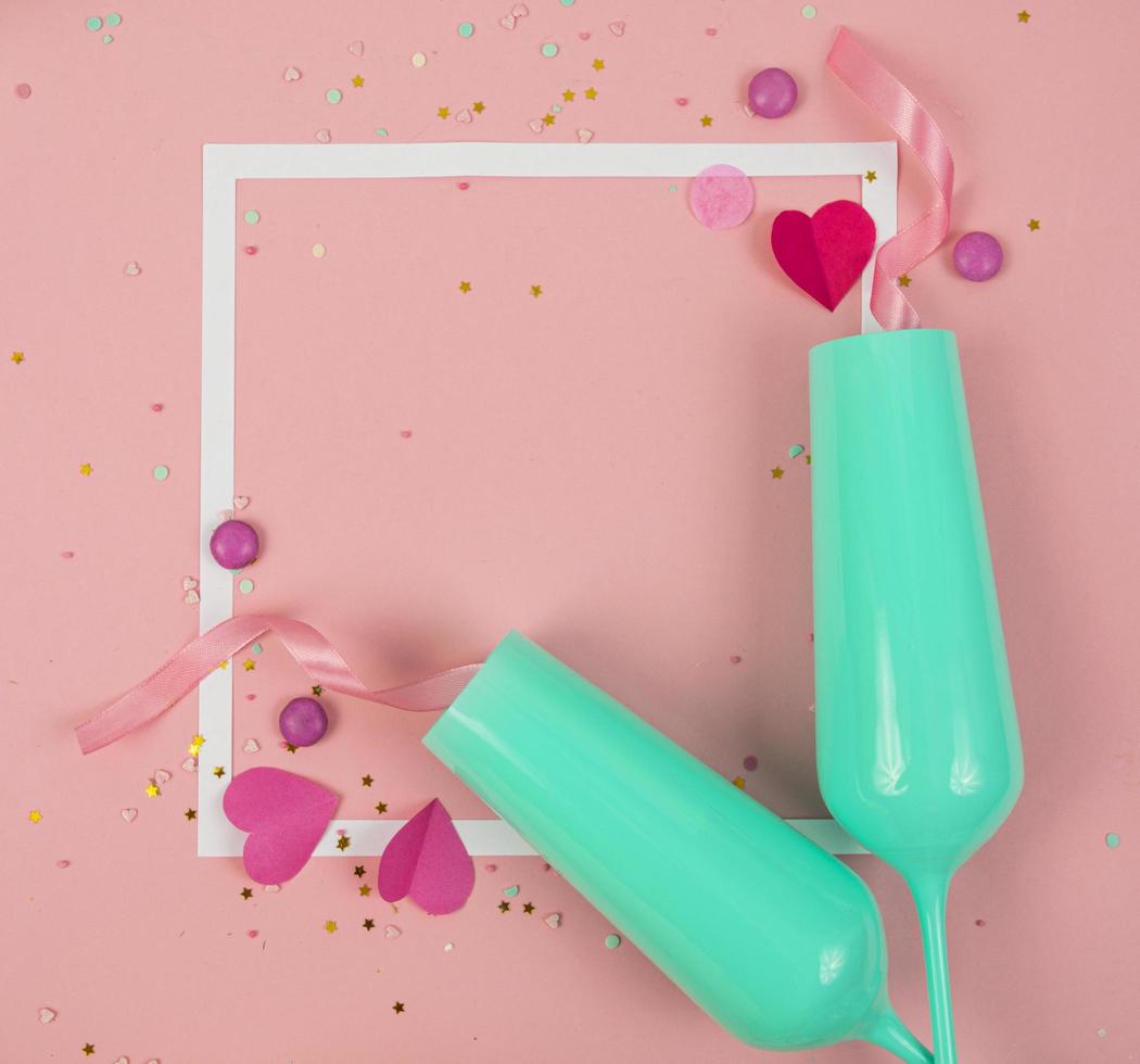 Party Holiday Background with ribbon, stars, birthday candles, empty frame and confetti on pink background. Photo