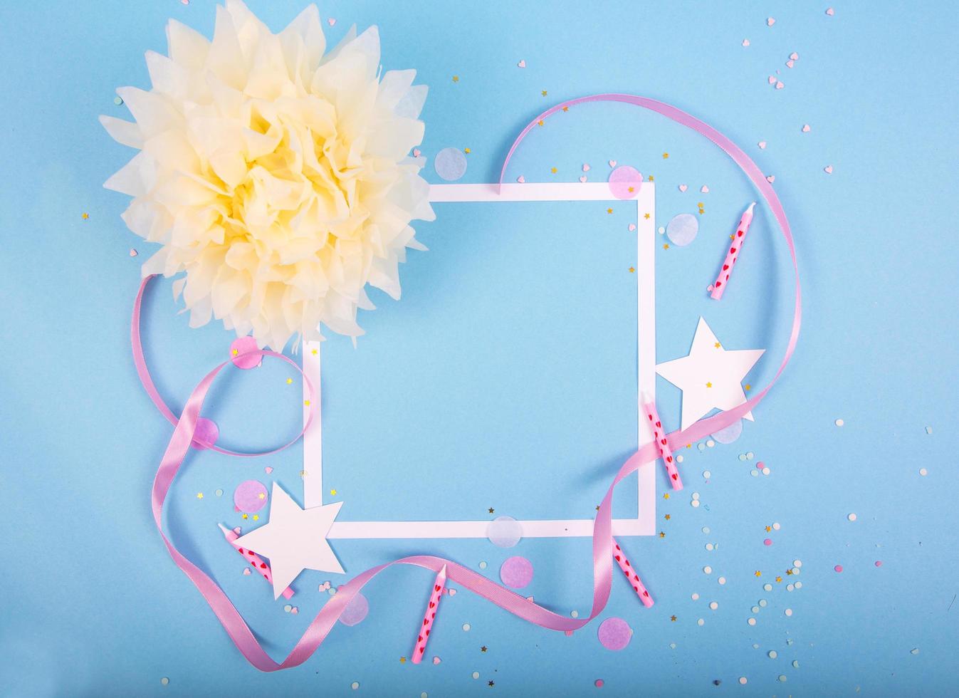 Party Holiday Background with ribbon, stars, birthday candles, gift box empty frame and confetti on blue background photo