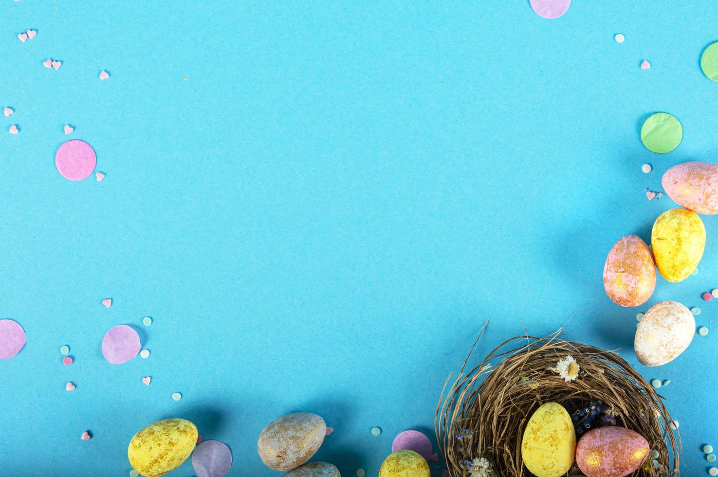 Colorful background with Easter eggs on blue background. Happy Easter concept. Can be used as poster, background, holiday card. Flat lay, top view, copy space. Studio Photo