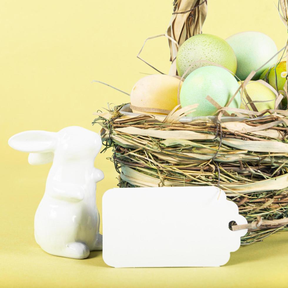 Colorful background with Easter eggs on yellow background. Happy Easter concept. Can be used as poster, background, holiday card. Flat lay, top view, copy space. Studio Photo