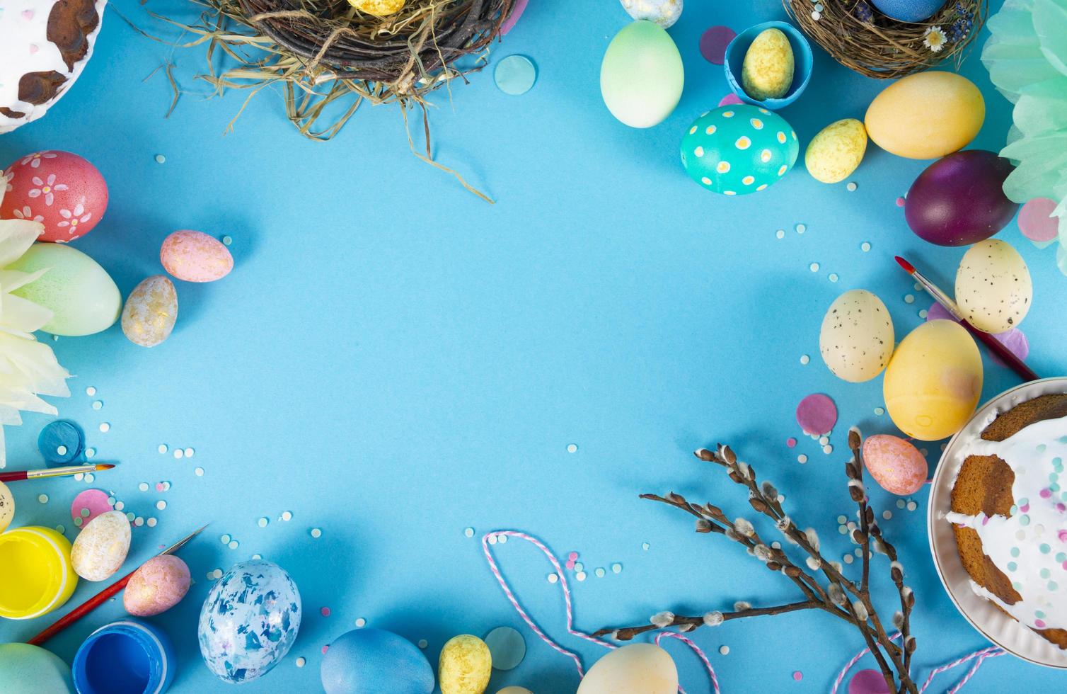 Colorful background with Easter eggs on blue background. Happy Easter concept. Can be used as poster, background, holiday card. Flat lay, top view, copy space. Studio Photo