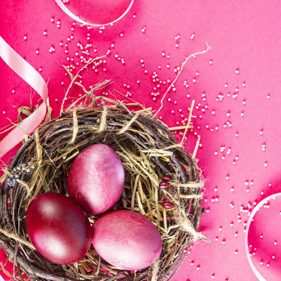 Colorful background with Easter eggs on red- background. Happy Easter concept. Can be used as poster, background, holiday card. Flat lay, top view, copy space. Studio Photo