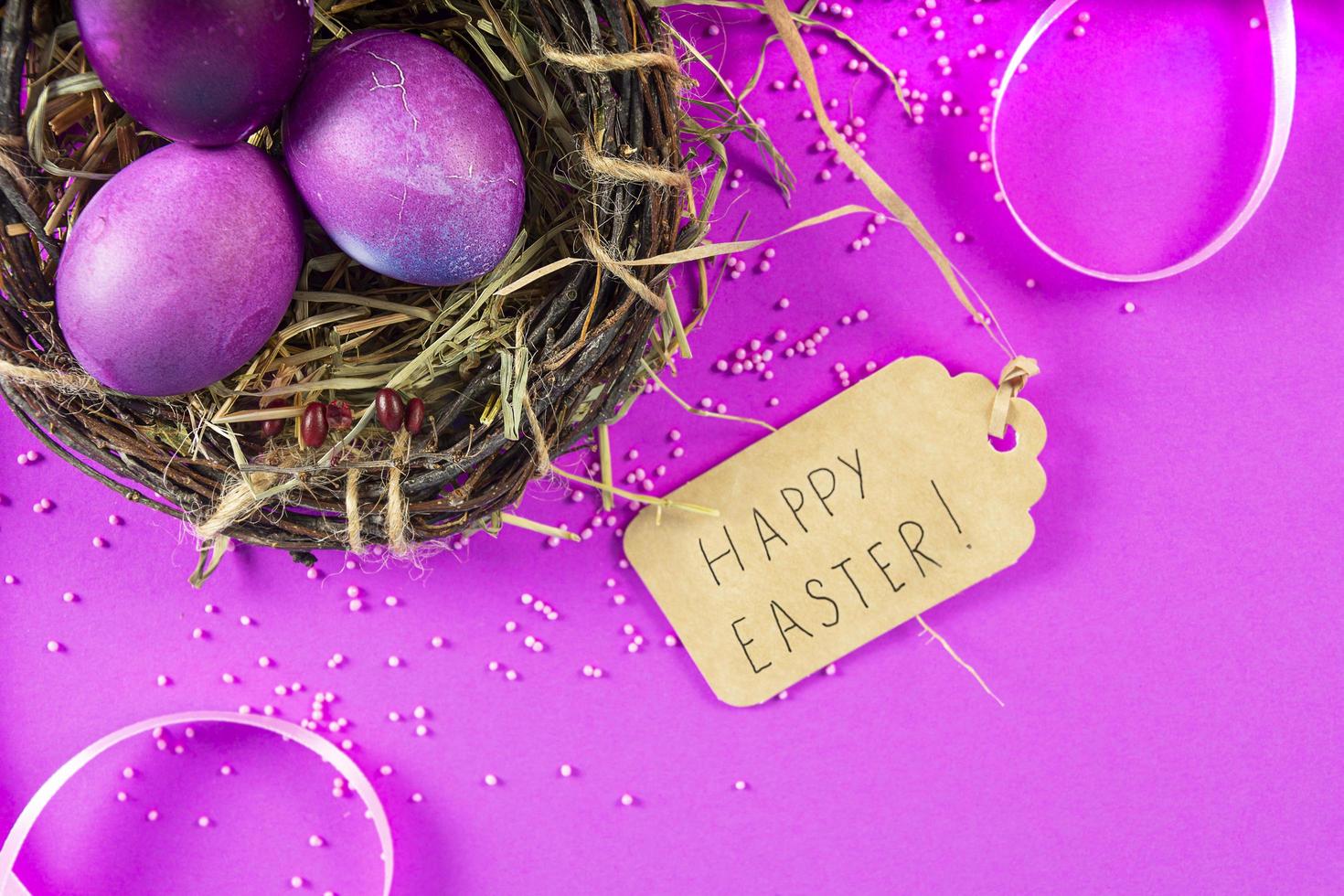 Colorful background with Easter eggs on pink background. Happy Easter concept. Can be used as poster, background, holiday card. Flat lay, top view, copy space. Studio Photo