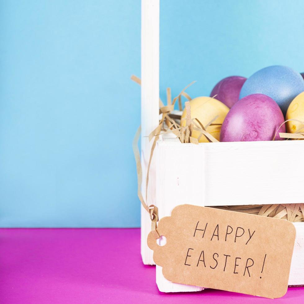 Colorful background with Easter eggs on pink and blue background. Happy Easter concept. Can be used as poster, background, holiday card. Flat lay, top view, copy space. Studio Photo