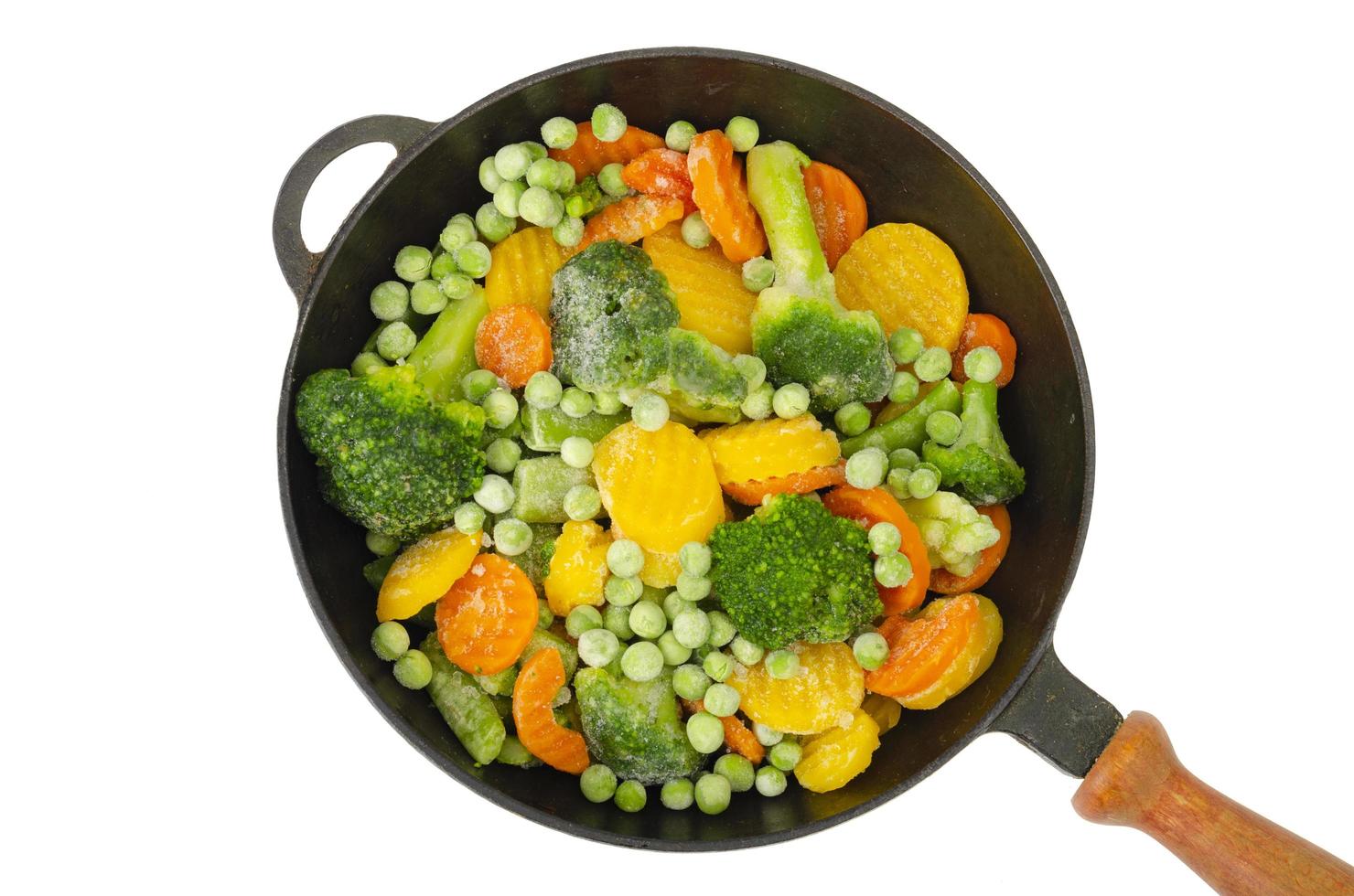 Pan with frozen pieces of vegetables isolated on white background. Studio Photo