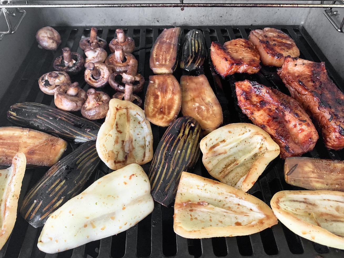 Pieces of vegetables and meat are grilled photo