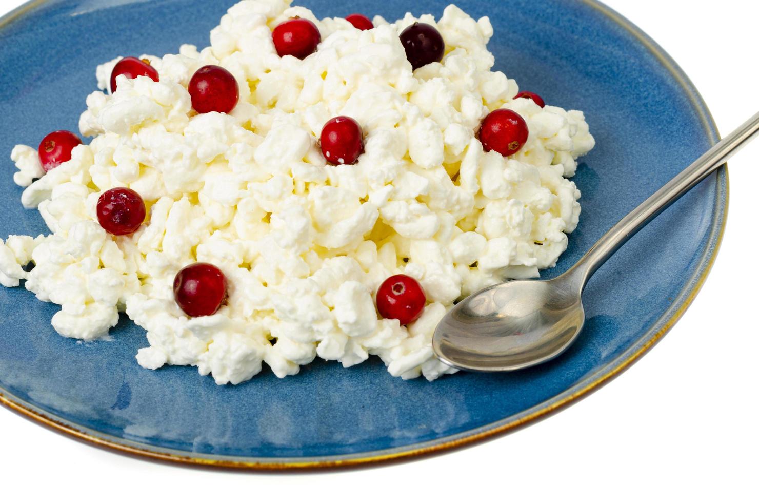 Milk products. Farm cottage cheese with red berries on plate. Studio Photo