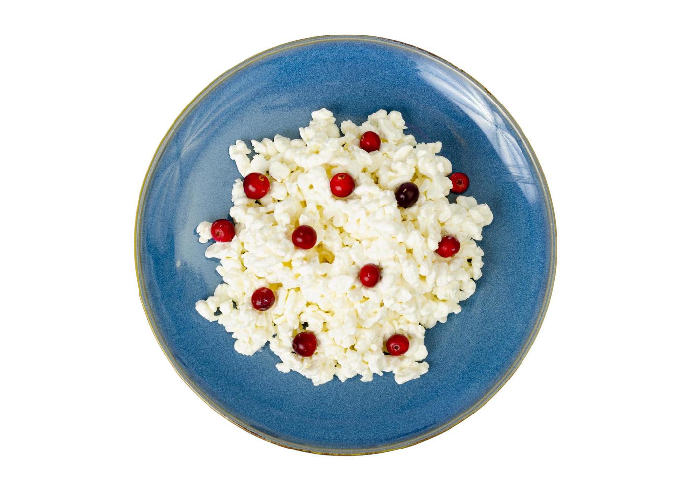 Milk products. Farm cottage cheese with red berries on plate. Studio Photo