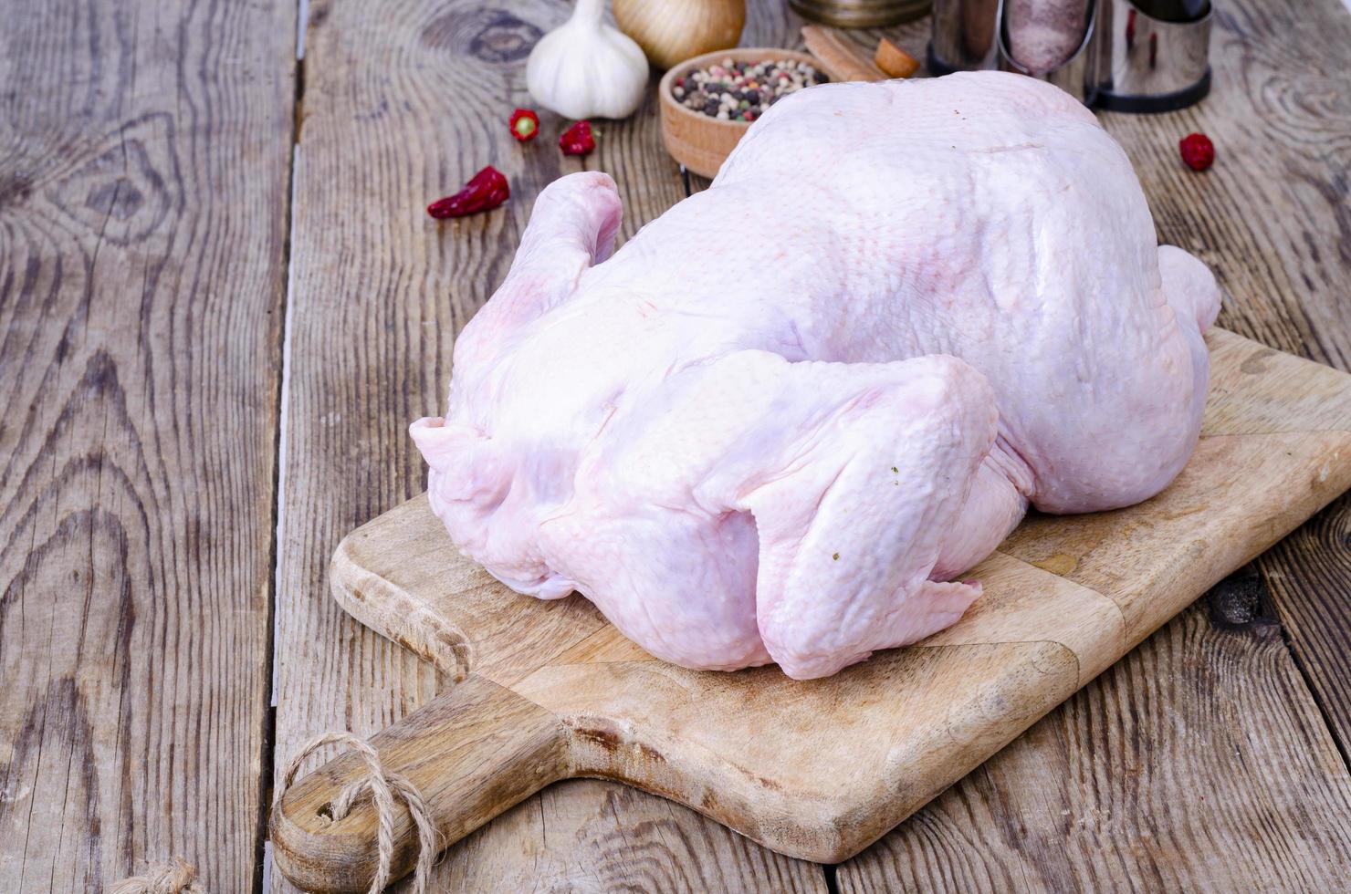 Raw chicken carcass on kitchen cutting board. Studio Photo