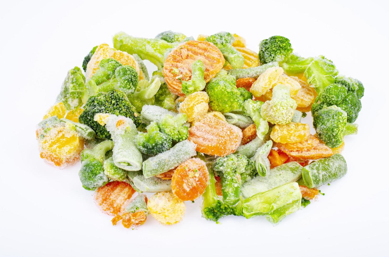 Pile of frozen raw vegetable pieces isolated on white background. Studio Photo. photo