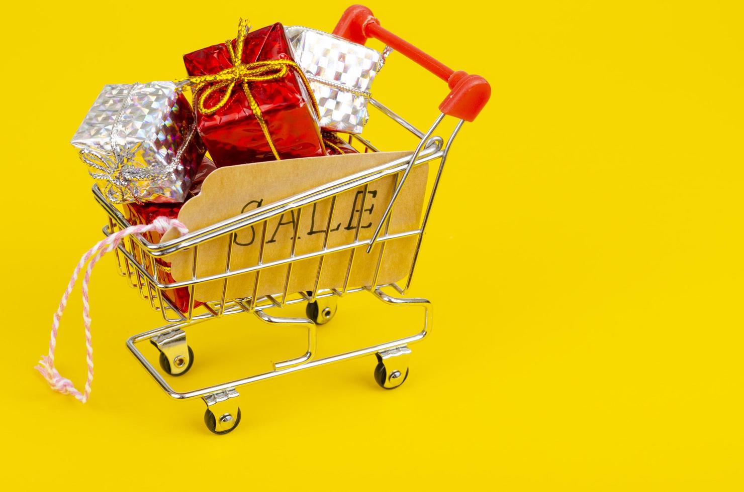 Seasonal sales. Shopping cart shopping cart on bright background photo