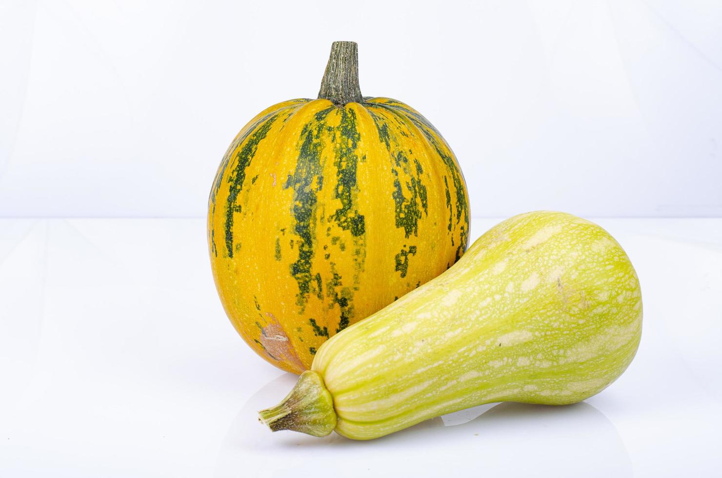 Small pumpkins of different shapes and varieties isolated on white background. Studio Photo. photo