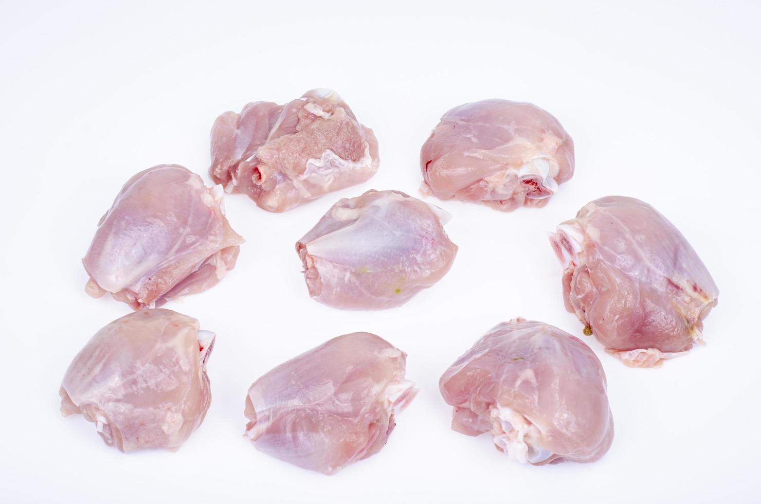 Pieces of cut raw chicken, leg thighs on white background. Studio Photo. photo