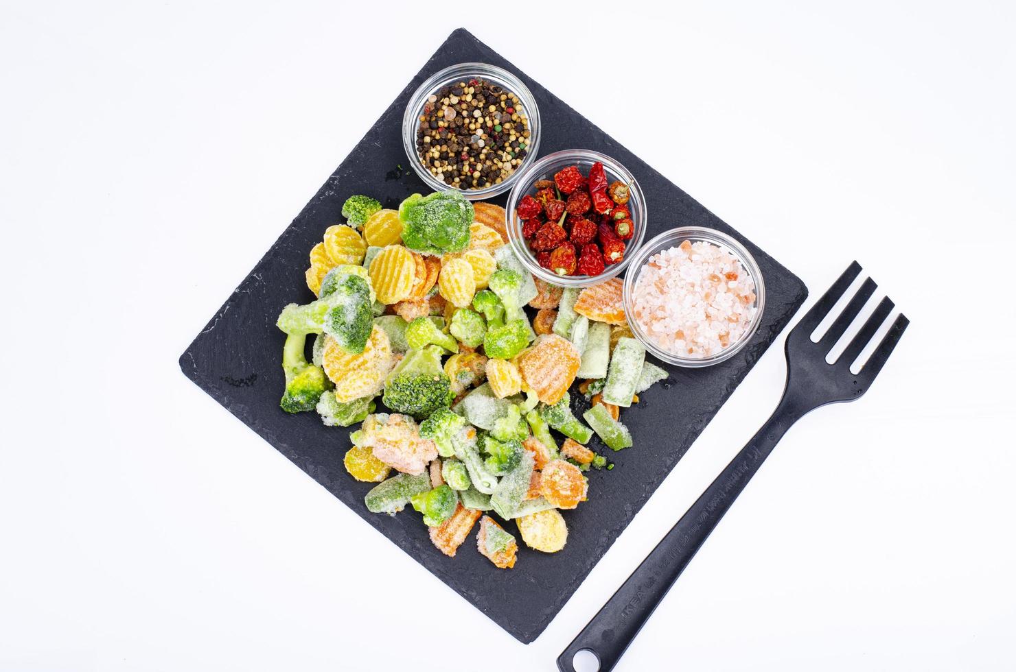 Mix of frozen vegetables on black. Studio Photo. photo