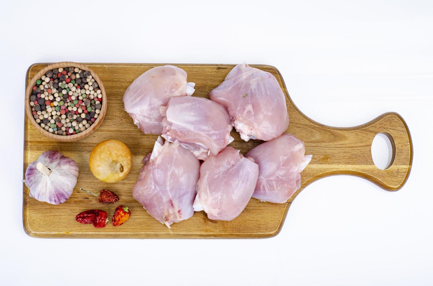 Pieces of cut raw chicken, leg thighs on white background. Studio Photo. photo