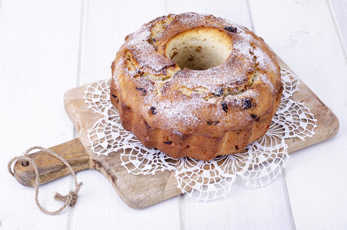 Sweet homemade muffin with raisins on wooden plank. Studio Photo